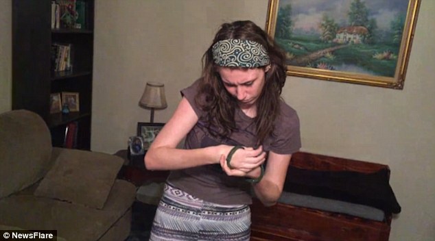 wrist monitor removal: person sliding electronic monitoring wristband off forearm