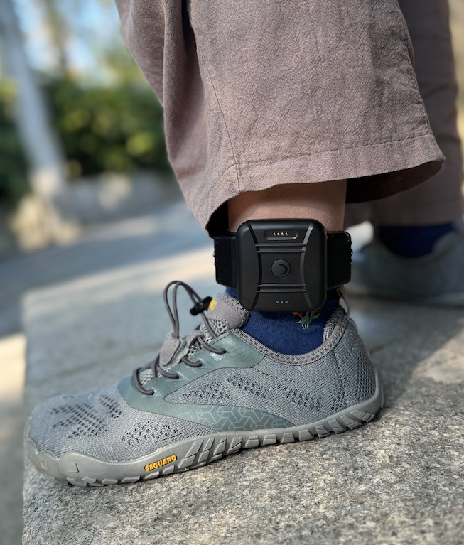 CO-EYE ONE GPS ankle monitor worn on ankle for domestic violence offender monitoring — 108g lightweight design with fiber-optic tamper detection