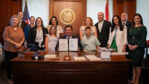 Florida Gov DeSantis signs HB 277 domestic violence reform bill into law May 21 2026 with survivors and Rep Debra Tendrich