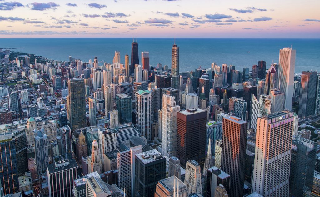 Chicago skyline and Cook County where the largest electronic monitoring program in America faces systemic crisis with 327 missing defendants