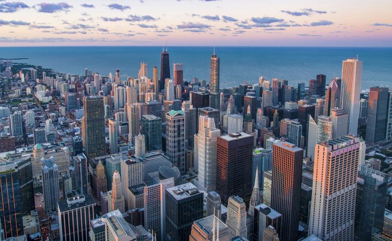 Chicago skyline and Cook County where the largest electronic monitoring program in America faces systemic crisis with 327 missing defendants